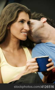 Close-up of a mid adult man kissing a young woman