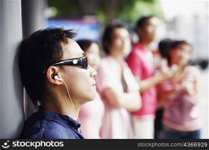 Close-up of a mid adult man listening to music