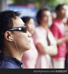 Close-up of a mid adult man listening to music