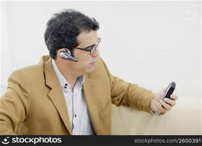 Close-up of a mid adult man looking at a mobile phone