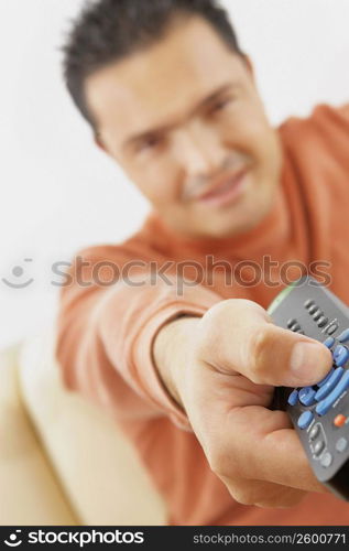 Close-up of a mid adult man operating a remote control