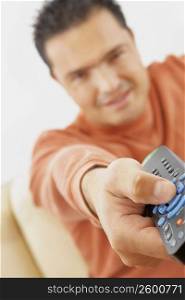 Close-up of a mid adult man operating a remote control