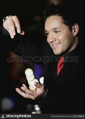 Close-up of a mid adult man playing with gambling chips in a casino