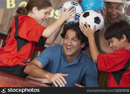 Close-up of a mid adult man playing with his family in a restaurant