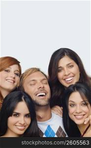 Close-up of a mid adult man posing with four young women