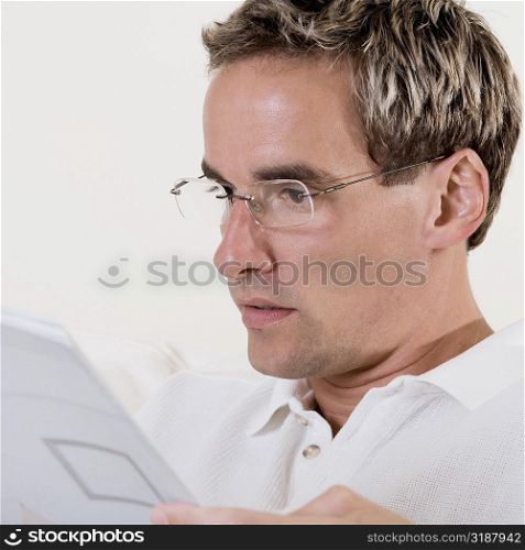 Close-up of a mid adult man reading a book
