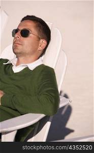 Close-up of a mid adult man reclining on a lounge chair