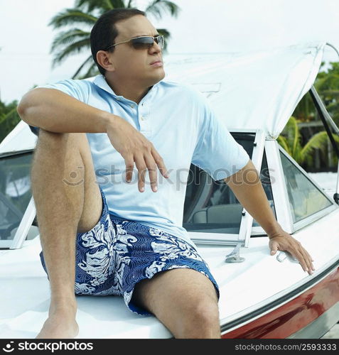 Close-up of a mid adult man sitting on a boat