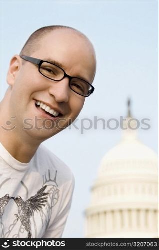 Close-up of a mid adult man smiling in front of a building, Capitol Building, Washington DC, USA