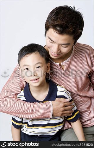 Close-up of a mid adult man smiling with his son