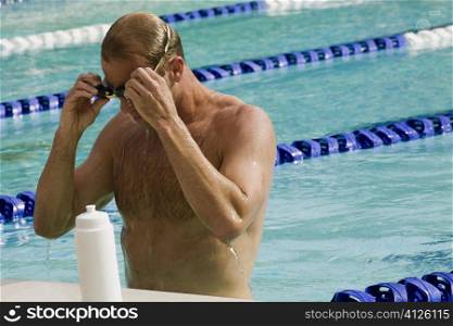 Close-up of a mid adult man standing in a swimming pool