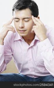 Close-up of a mid adult man suffering from a headache