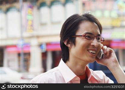 Close-up of a mid adult man talking on a mobile phone and smiling