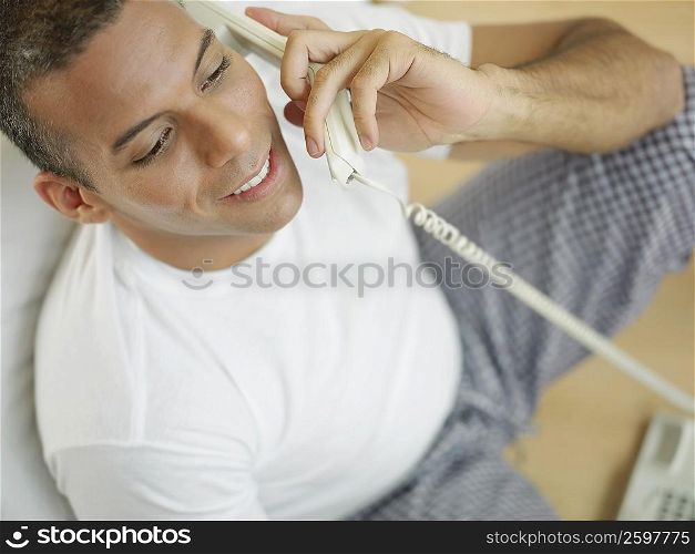 Close-up of a mid adult man talking on the telephone and smiling