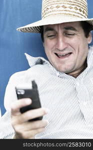 Close-up of a mid adult man text messaging on a mobile phone