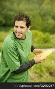 Close-up of a mid adult man throwing a plastic disc