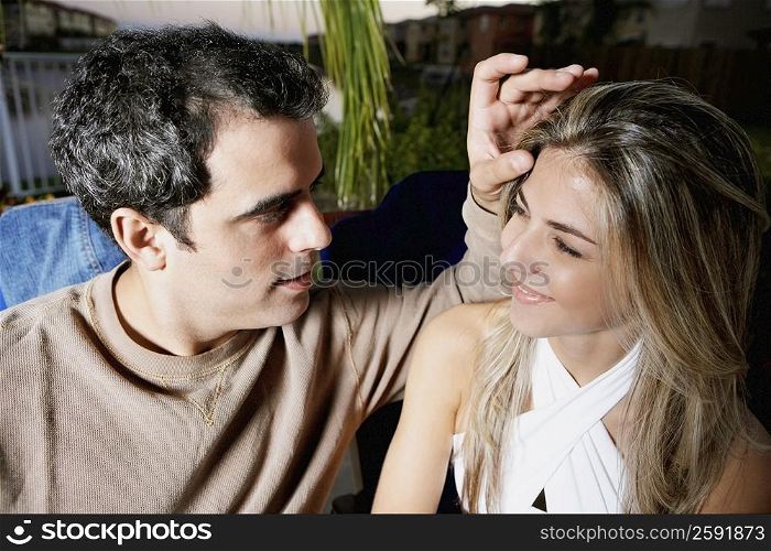 Close-up of a mid adult man touching a mid adult woman&acute;s forehead