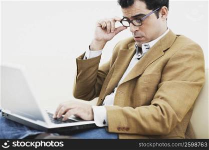 Close-up of a mid adult man using a laptop