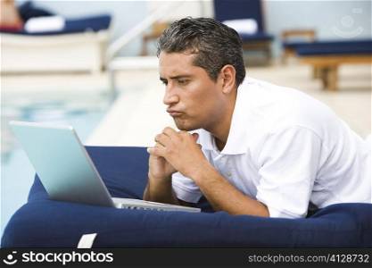Close-up of a mid adult man using a laptop
