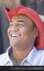 Close-up of a mid adult man wearing a cowboy hat and smiling