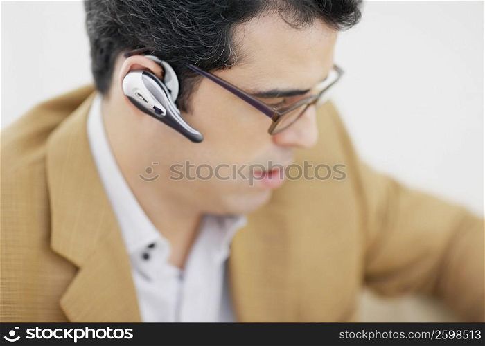 Close-up of a mid adult man wearing a hands free device