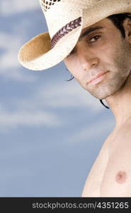Close-up of a mid adult man wearing a hat