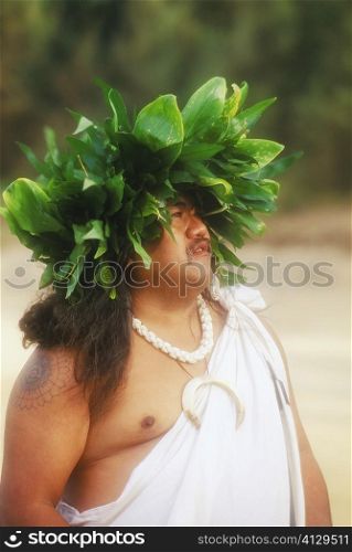 Close-up of a mid adult man wearing a headdress, Hawaii, USA