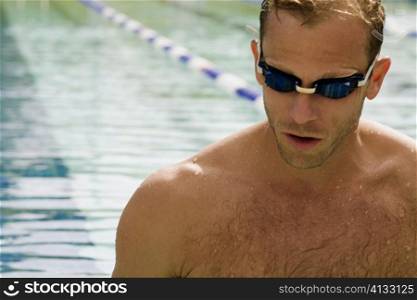 Close-up of a mid adult man wearing swimming goggles