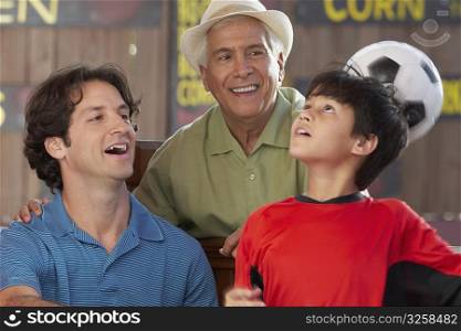 Close-up of a mid adult man with his father and son in a restaurant