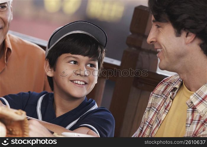 Close-up of a mid adult man with his son and father smiling