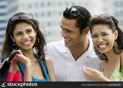 Close-up of a mid adult man with two young women smiling