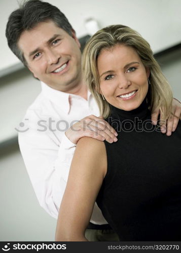 Close-up of a mid adult woman and a mature man smiling together