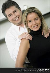 Close-up of a mid adult woman and a mature man smiling together