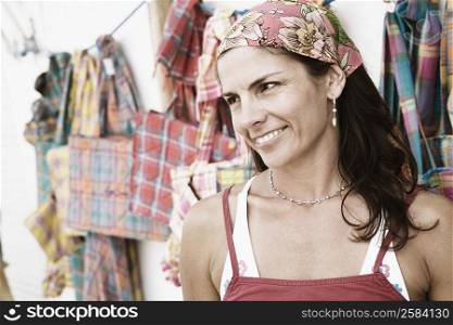 Close-up of a mid adult woman at a market stall and smiling