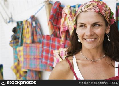 Close-up of a mid adult woman at a market stall and smiling