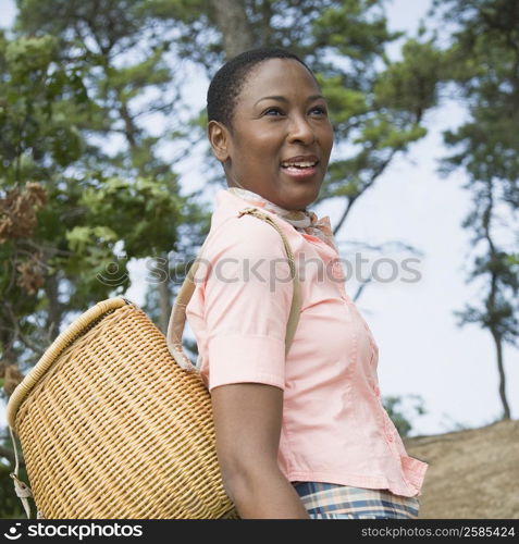 Close-up of a mid adult woman carrying a basket on her back