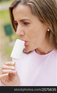 Close-up of a mid adult woman eating an ice-cream