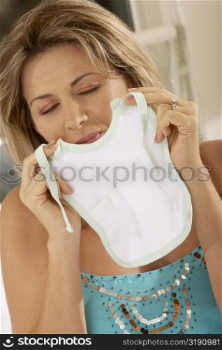 Close-up of a mid adult woman holding a baby bib