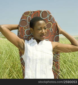 Close-up of a mid adult woman holding a body board and smiling