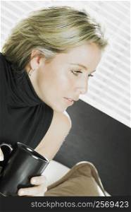 Close-up of a mid adult woman holding a cup of coffee