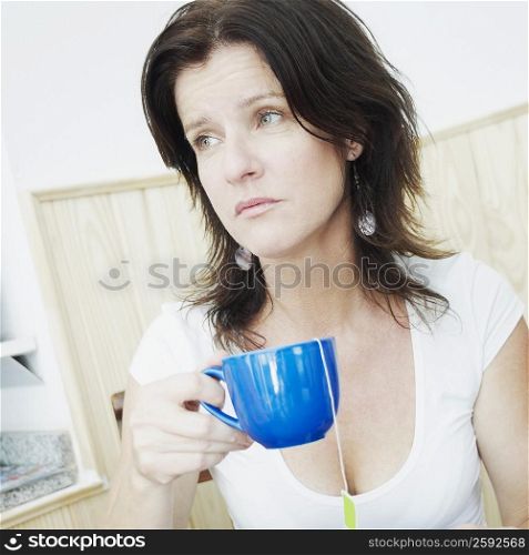 Close-up of a mid adult woman holding a cup of tea