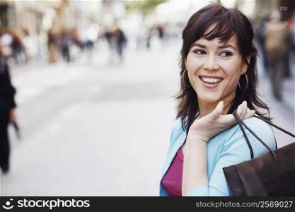 Close-up of a mid adult woman holding a shopping bag