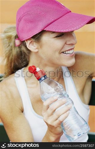 Close-up of a mid adult woman holding a water bottle
