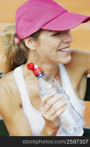 Close-up of a mid adult woman holding a water bottle