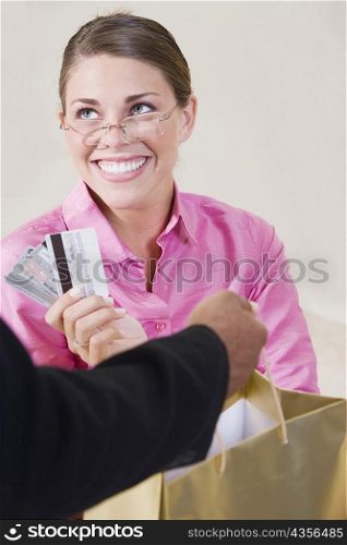 Close-up of a mid adult woman holding credit cards