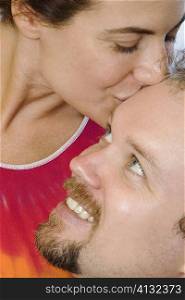 Close-up of a mid adult woman kissing a mid adult man