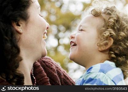 Close-up of a mid adult woman laughing with her daughter
