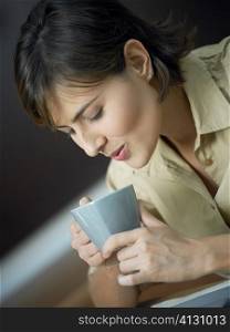 Close-up of a mid adult woman looking at a cup
