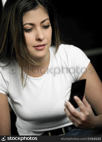 Close-up of a mid adult woman looking at a mobile phone