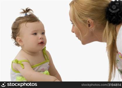 Close-up of a mid adult woman looking at her daughter